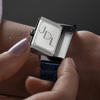 Jaeger-LeCoultre-Reverso Watch with initials on a wrist against a dark background